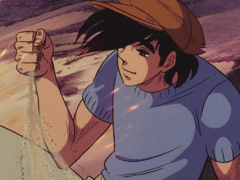 A man sits and watches sand slip through their clasped hand